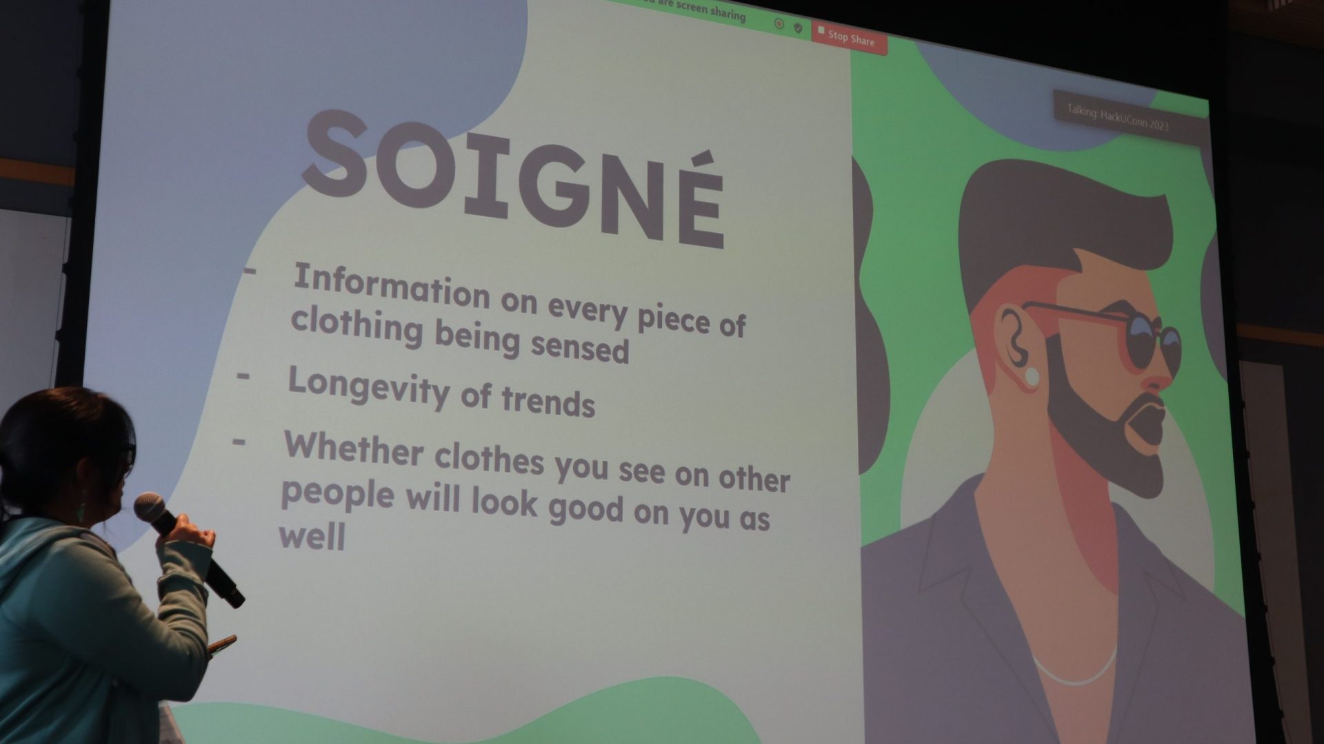 Students presenting in front of their slides at HackUConn 2023