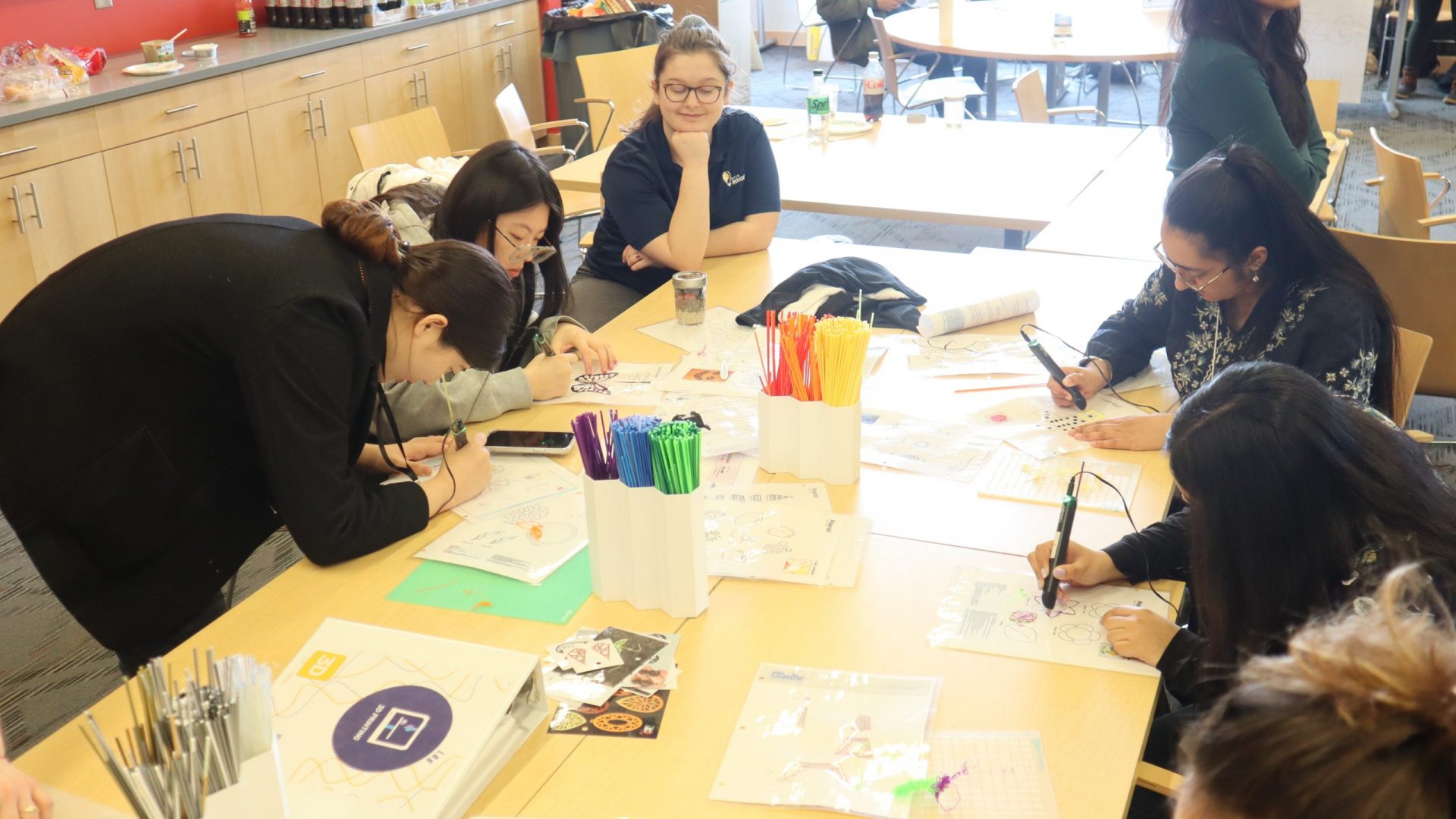 Students creating art with 3D printing pens