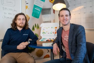 Devin McNamara ’21 (CLAS), left, and Ryan Gresh ’09 (ENG) pose for a photo in The Feel Good Lab’s office in UConn Farmington’s Technology Incubation Program building on Jan. 16, 2023. (Sydney Herdle/UConn Photo)